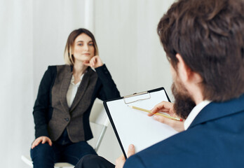 business man and woman sitting on the couch communication hiring job interview