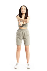 Fototapeta premium Cocky attitude young beautiful summer woman showing thumbs up with crossed arms. Full body portrait isolated on white background