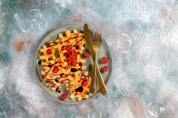 Homemade waffles with raspberries and red currants.