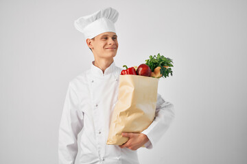 Chef with a package of groceries kitchen cooking food work