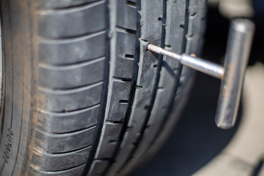 car tire closeup, people patching tubeless tires