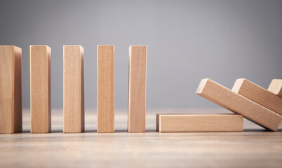 Falling wooden domino. Business. Crisis. Risk