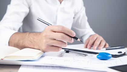 Fototapeta premium Architect drawing construction plan. Working in office