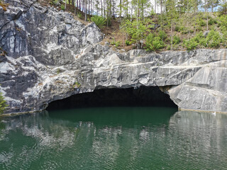 View from the water of the grotto and the slope of the flooded Marble Canyon, where trees grow, in...