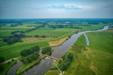 Airial view of a weir in the river Vecht. Dutch river in a colorful landscape. Water authority Drents Delta Overijssel