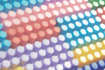 children's play background: the plane of plastic multi-colored bricks, blur, selective focus