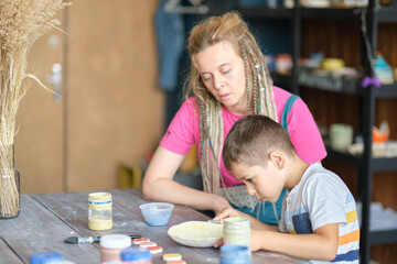 workshop for kids. Children learning how to use clay for making beautiful dishes. Workshop, master class.