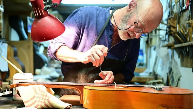 Man working at a Workshop with Musical instruments