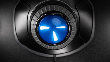 close-up Trackball Computer Mouse on a black background. Control Device with Scroll Wheel. Top View