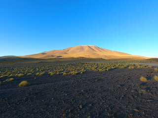 A hill at sunset in the stone desert of Bolivia near the city of Uyuni. Eduardo Avaroa Andean Fauna National Reserve