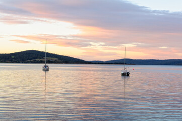 Fototapeta na wymiar Sailing boats at anchor in Georges Bay - St Helens, Tasmania, Australia