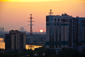 the setting sun over a residential area by the river 