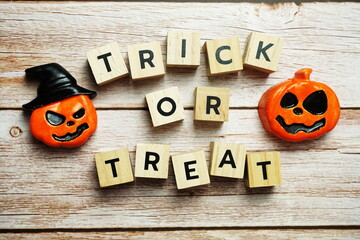 Trick or Treat alphabet letter with Halloween decoration on wooden background