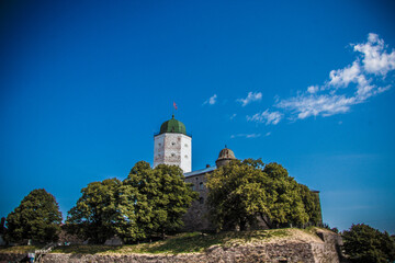 old fortress made of bricks of white color against a background of blue sky close-up 