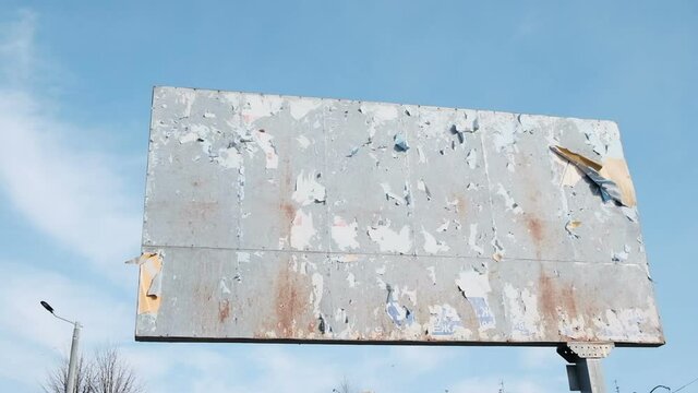 Empty old rusty billboard near highway and overpass