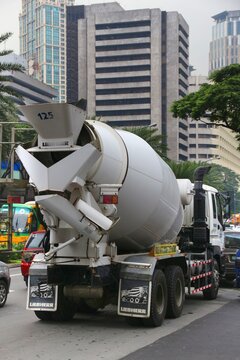 MANILA, PHILIPPINES - DECEMBER 7, 2017: Concrete mixer truck in Makati City, Metro Manila, Philippines. Metro Manila is one of the biggest urban areas in the world with 24 million people.