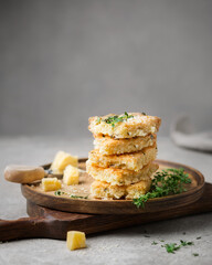 Traditional Scottish cookies. Shortbread with thyme and parmesan cheese. The cuisine of Scotland. Salted cookies on a wooden plate. Cheese cookies. Square baking. Space for text