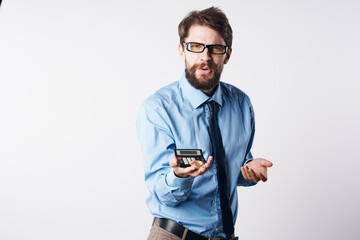 a man in a blue shirt with a calculator in his hands finance Professional