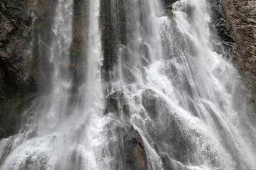 Fototapeta na wymiar waterfall on the background of the rock