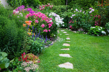 Garden with blooming flowers in the middle of the summer - Powered by Adobe