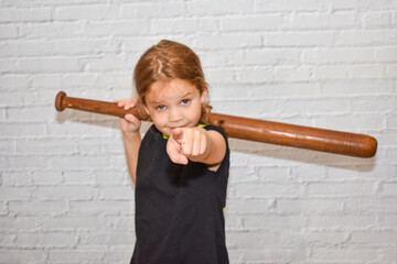 the child a girl with a baseball bat plays a bully