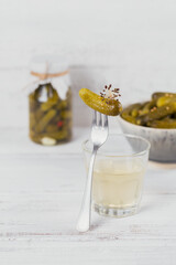 Pickled juice, pickle and marinated cucumber in bowl. Clean eating, vegetarian food concept