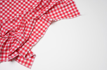 folded cotton red white checkered napkin on a white background
