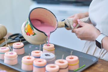Hand made yellow candles from natural bee wax. The process of creating candles with your own hands. Master class on creating candles at table, closeup