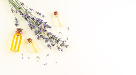 Banner of lavender essential oil bottles or perfume with flowers