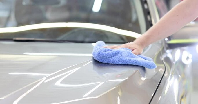 Man cleaning car with microfiber cloth 4k movie