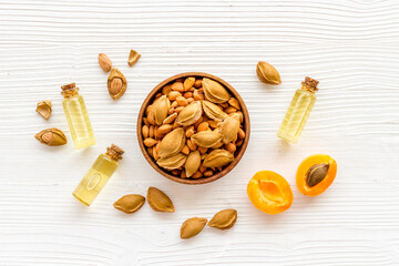 Bottles of apricot kernel oil with ripe apricot fruits
