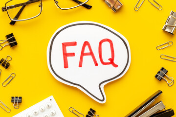 Text faq frequently asked questions on office table with stationery