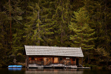 wilderness wooden house by a lake in the mountains