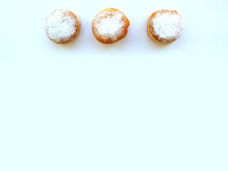 Fried donuts sprinkled with powdered sugar. 