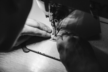 Leather worker workshop. Working process of leather craftsman.