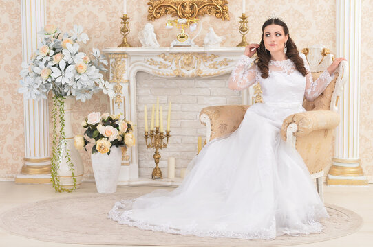 portrait of young beautiful bride in white dress posing