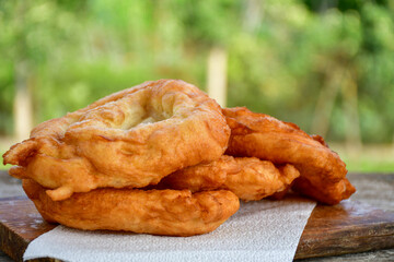 Traditional Bulgarian home made deep fried  patties  covered with sugar  оn rustic backgroud.Mekitsa or Mekica,  on wooden  rustic  background. Made of kneaded dough that is deep fried 