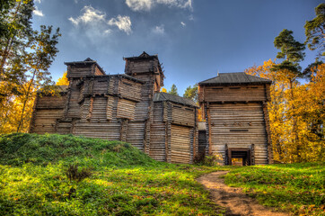 Reconstructed wooden castle in Tervete on autumn day, Latvia. - obrazy, fototapety, plakaty