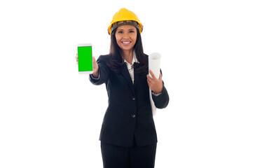 portrait of mixed race asian/caucasian engineer woman with helmet holding blueprints and showing green screen mobile phone isolated white background