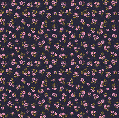 Beautiful floral pattern in small abstract flowers. Small pink flowers. Dark Blue background. Ditsy print. Floral seamless background. The elegant the template for fashion prints. Stock pattern.