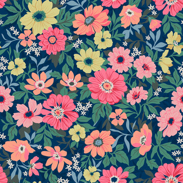 Seamless vector floral pattern. Liberty background of bright colorful realistic flowers. Print with bouquets of flowers from the garden. Bright yellow and pink chrysanthemums on a blue background. 