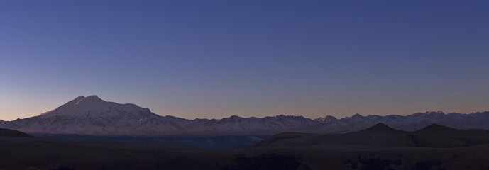 Fototapeta na wymiar Mount Elbrus. Snow-capped mountain peaks of Gemini. The North Caucasus. Panoramic mountain views.