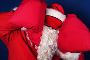 Rest. Funny Santa Claus, sleep and pillows.
