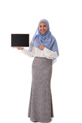 full length portrait of young asian muslim woman in hijab pointing finger towards the chalkboard isolated over white background