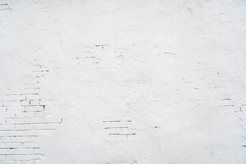 Abstract textured background of old white brick wall with plaster