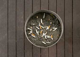 Many burn used cigarettes. Cigarette butts and ash. Smoking. Dirty. Toxic chemicals for environment.