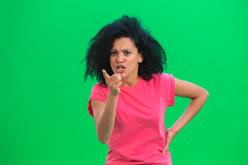 Portrait of young female African American swears and shakes viciously with his index finger. Black...