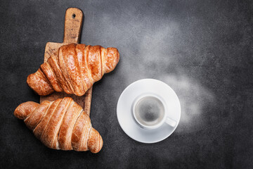 croissants lie on the black breakfast table