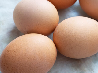 Chicken eggs lie on a fabric surface, close-up. Multi-colored chicken eggs.