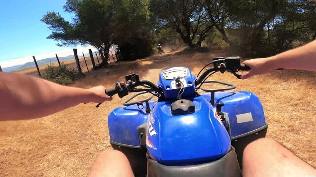 Driving a quad on off-road in Spain. First-person view on an action camera. Point of view, POV riding Quad Motor bike through the forest. Adventures of off-road on ATVs. 